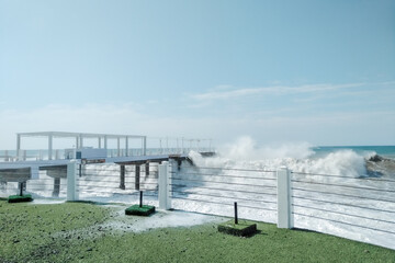 Obraz premium Waves crash on the shore. Storm into the rocky beach. Landscape of Batumi, Georgia