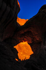 Shadow of hikers at Double Arch, Arches National Park, Moab, Utah, USA.
