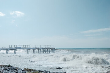 Fototapeta na wymiar Waves crash on the shore. Storm into the rocky beach. Landscape of Batumi, Georgia