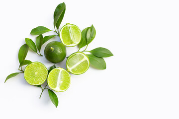 Fresh limes with green leaves on white background.