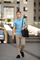 Young  business man in classic look walking on the street with Briefcase Designer Leather Laptop Satchel Portfolio Messenger Bag.  different color of bag and no logo.