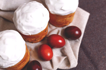 Easter pastries and colored eggs on a textile background. Traditional pastries for Orthodox holidays.