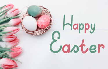 Pink tulips and easter Eggs in the nest isolated on white wood Background.