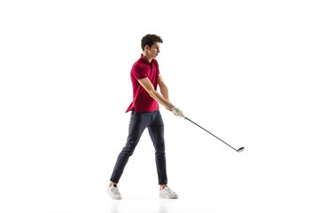 Golf player in a red shirt taking a swing isolated on white studio background with copyspace. Professional player practicing confident, emotions and facial expression. Sport, motion, action concept.