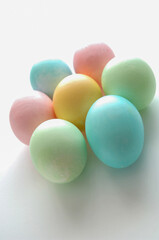 colored and decorated eggs for easter breakfast in italy on white background
