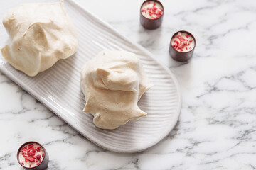 Homemade sweet meringue cookies on white marble table. Delicious and light dessert. Selective focus