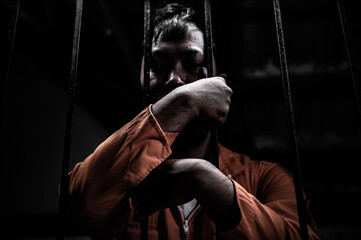 Asian man desperate at the iron prison,prisoner concept,thailand people,Hope to be free,Serious...