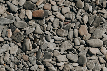 Small stone texture. Sea gray pebbles background. Sea stones.