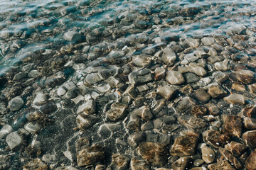 The Black Sea is clear water. Beautiful pebble beach. Rocky shore background.