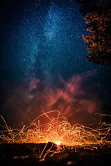 Luminous fire patterns on night sky background