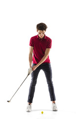 Golf player in a red shirt taking a swing isolated on white studio background with copyspace. Professional player practicing confident, emotions and facial expression. Sport, motion, action concept.