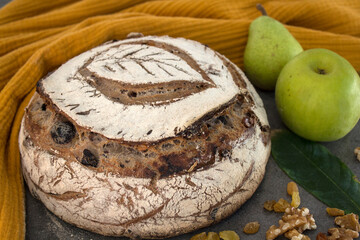 Crusty bread on a yellow kitchen towel. Top view photo of fresh baked sourdough bread.  Still life food.