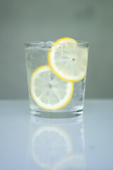 Glasses of water filled with slices of lemons. Selective focus