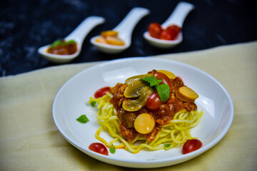 Delicious classic Italian spaghetti with tomato sauce, Parmesan cheese and mint leaves on a plate. There is a writing area.