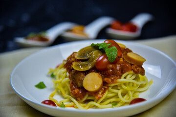 Delicious classic Italian spaghetti with tomato sauce, Parmesan cheese and mint leaves on a plate. There is a writing area.