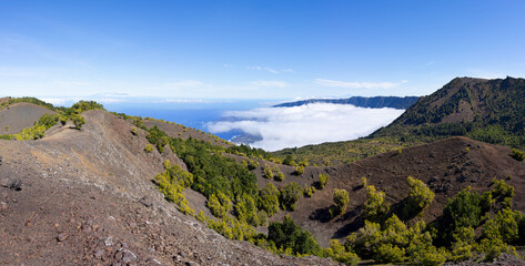 Fototapeta na wymiar El Hierro, Kanarische Inseln - Blick vom Kammweg des Vulkans Tanganasoga zum bewölkten El Golfo Tal, rechts der höchste Berg Malpaso