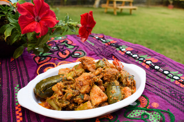 Food authenthic indiand village style gujarati dish surti undhiyu. mixed vegetable item coked with stuffed brinjal, potato, yams, methi muthiya dhokli. papdi its sweet and spicy