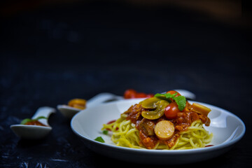Delicious classic Italian spaghetti with tomato sauce, Parmesan cheese and mint leaves on a plate. There is a writing area.