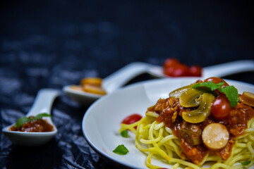 Delicious classic Italian spaghetti with tomato sauce, Parmesan cheese and mint leaves on a plate. There is a writing area.