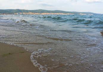 Sea surf, waves rolls on a sandy beach