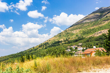Fototapeta na wymiar Panoramic view of beautiful landscape mountains and of small haven of village, Adriatic coast, Montenegro.