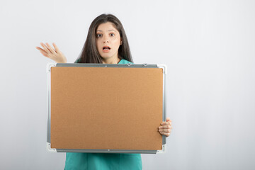 Shocked Young medical worker holding information board 