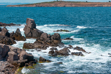 Sea surf day landscape. Sea waves with white foam breaks on stones. Sozopol. Bulgaria