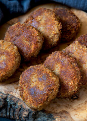 Juicy homemade cutlets on a wood board background