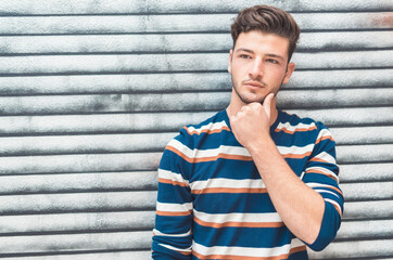 Expressive beautiful young man against metalic background