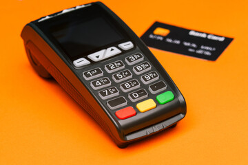 Close-up of a payment terminal and a credit card. Payment for purchases by credit card. E-commerce. Business concept