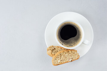 A cup of coffee with Italian biscotti cookie. Top view fresh baked cookie with white cup of coffee. Copy space. Classic recipe