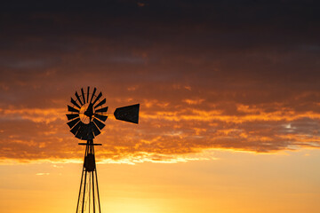 Windmill in the sunset, at the fields of Buenos Aires, Argentina