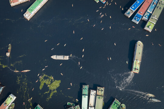 Aerial view of colourful ferry boat docket at small wharf along Buriganga river in Keraniganj, Dhaka, Bangladesh.