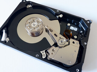 Repair broken computer part, close up of open hard disc drive (hdd) with platters, spindle,...