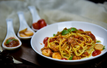 Delicious classic Italian spaghetti with tomato sauce, Parmesan cheese and mint leaves on a plate. There is a writing area.