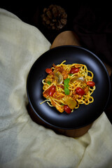 Delicious classic Italian spaghetti with tomato sauce, Parmesan cheese and mint leaves on a plate. There is a writing area.