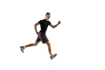 Running. Young caucasian male model in action, motion isolated on white background with copyspace. Concept of sport, movement, energy and dynamic, healthy lifestyle. Training, practicing. Authentic.