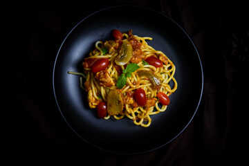 Delicious classic Italian spaghetti with tomato sauce, Parmesan cheese and mint leaves on a plate. There is a writing area.