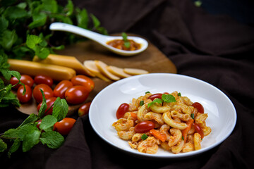 Delicious classic Italian spaghetti with tomato sauce, Parmesan cheese and mint leaves on a plate. There is a writing area.