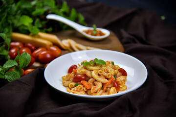 Delicious classic Italian spaghetti with tomato sauce, Parmesan cheese and mint leaves on a plate. There is a writing area.
