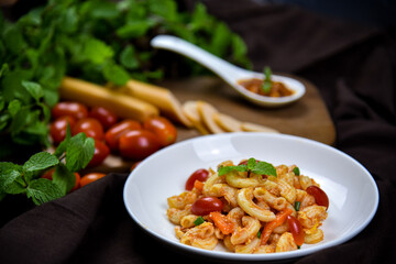 Delicious classic Italian spaghetti with tomato sauce, Parmesan cheese and mint leaves on a plate. There is a writing area.