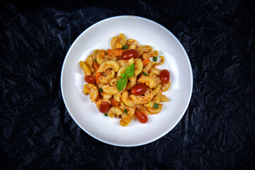 Delicious classic Italian spaghetti with tomato sauce, Parmesan cheese and mint leaves on a plate. There is a writing area.