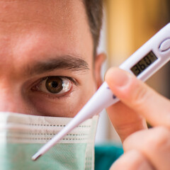 Doctor with mask and thermometer in Italy