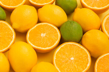 Citrus fruits isolated on yellow background.