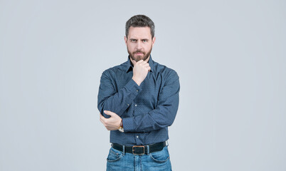 Clothing for the serious man. Bearded man think grey background. Serious look. Chin propping