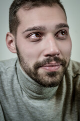 Fototapeta premium Portrait of a sad young bearded man who is crying 