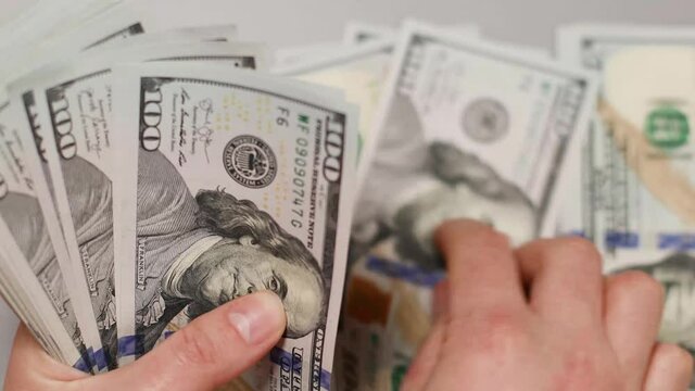 Hands of woman counting money a the office or bank. Concept of investment, success, financial prospects or career advancement.