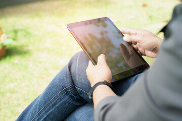 Asian  woman holding mobile phone to communication in business at park.