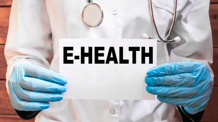 The doctor's blue - gloved hands show the word E-HEALTH - . a gloved hand on a white background. Medical concept. the medicine