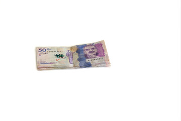 Obraz na płótnie Canvas Dinero apilado sobre fondo blanco, Billetes de moneda Colombiana. 